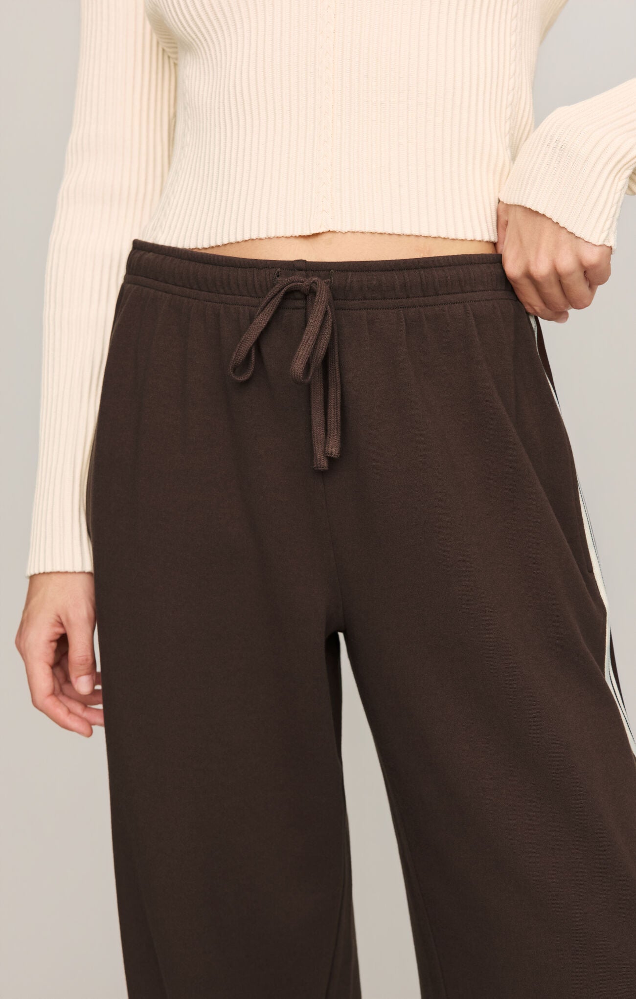 Effortlessly polished and incredibly comfortable, these high-rise knit lounge pants feature a relaxed silhouette, adjustable drawcord waist, and functional pockets for everyday versatility.