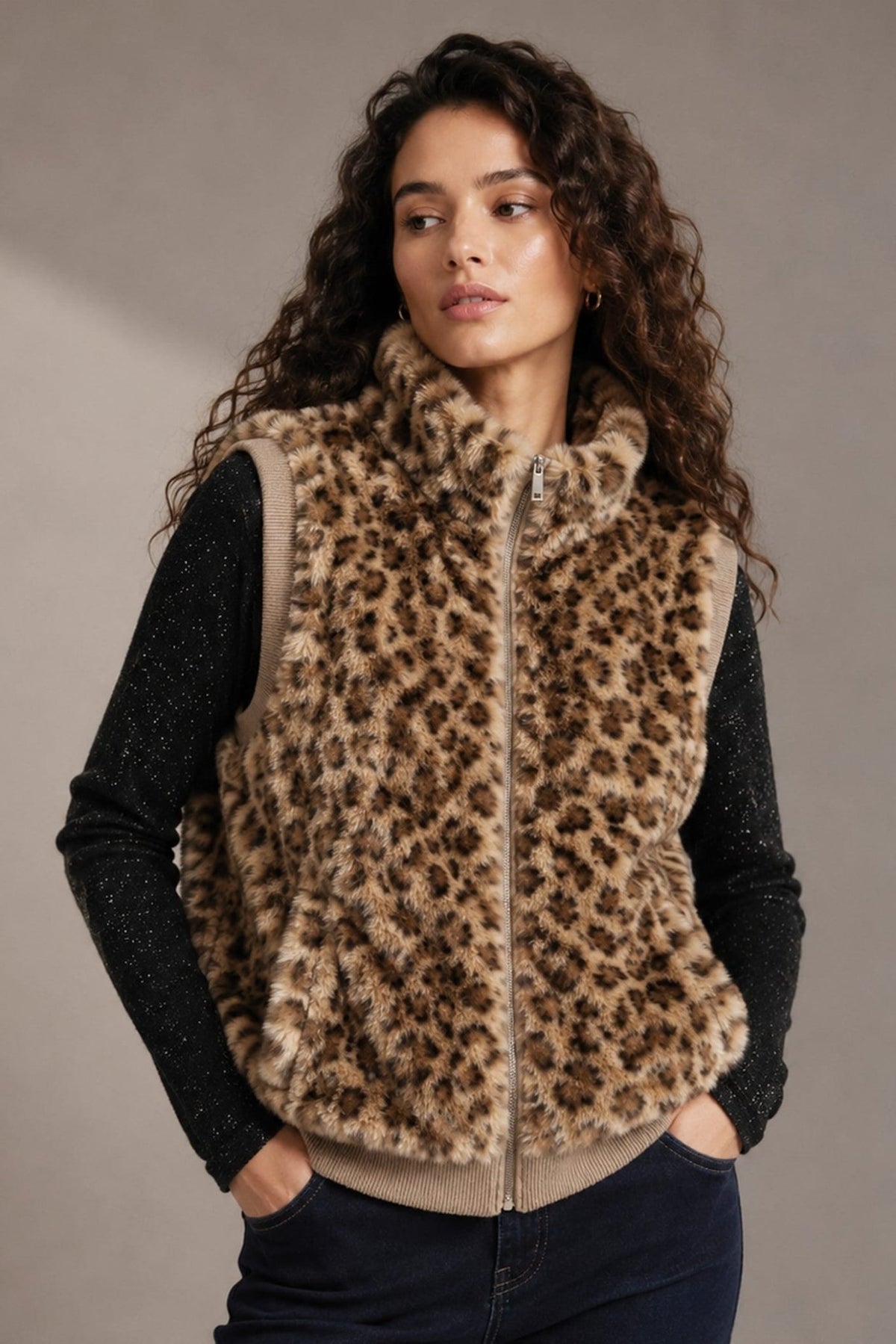 Make a bold statement with the Bianca Leopard Faux Fur Vest, featuring plush texture, a polished stand collar, and ribbed trim for a chic layered look.

