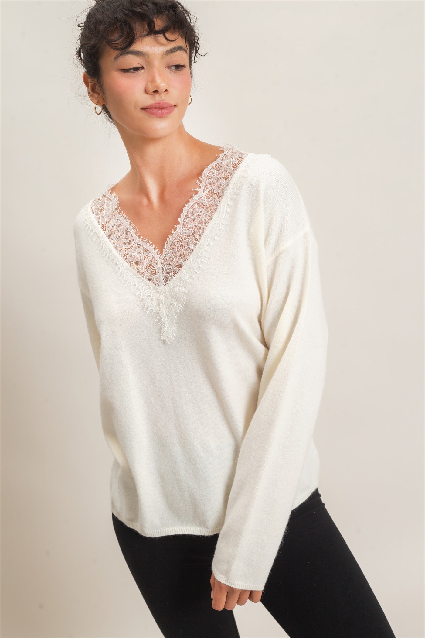 A feminine lace trim V-neck sweater featuring a relaxed silhouette, soft knit fabric, and elegant details for effortless everyday style.