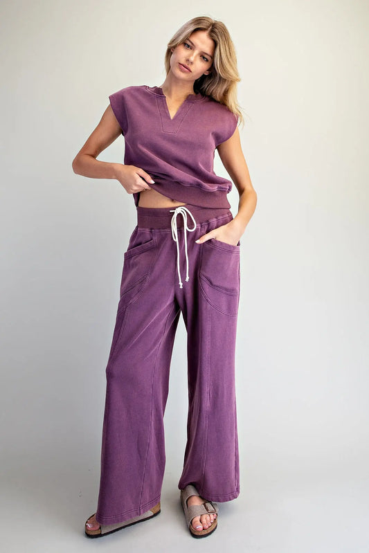 The perfect blend of comfort and style, this relaxed knit lounge set features a notched neck cap sleeve top and wide leg pants.