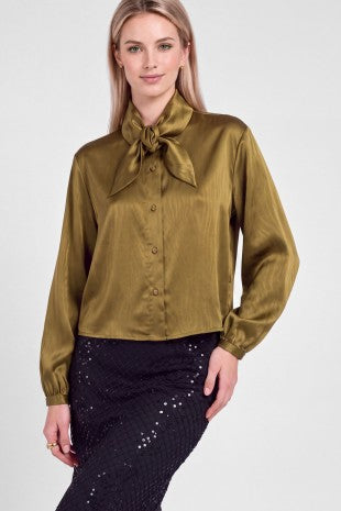 A lustrous satin blouse with a subtle zebra pattern, elegant bow-tie neckline, and relaxed cropped silhouette for a sophisticated statement look.